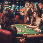 Upper class friends gambling in a casino